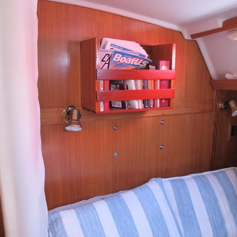 Slide: The Image of Wooden interior of 1997 Catalina 42 MkII yacht with bookshelf and striped cushion. - 36