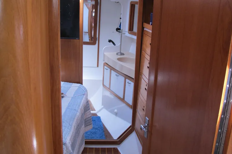 Slide: The Image of Interior of a 1997 Catalina 42 MkII sailboat, featuring a cozy cabin and bathroom. - 37