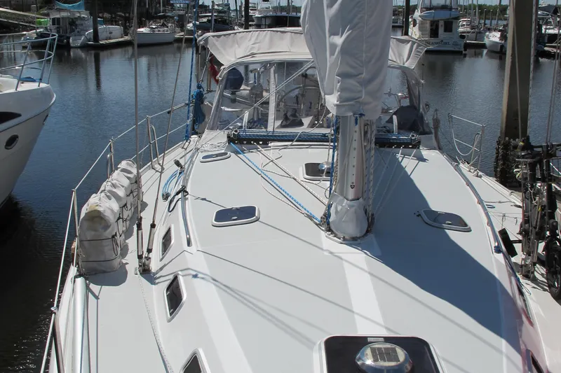 Slide: The Image of 1997 Catalina 42 MkII sailboat docked in marina, showcasing deck and rigging. - 4