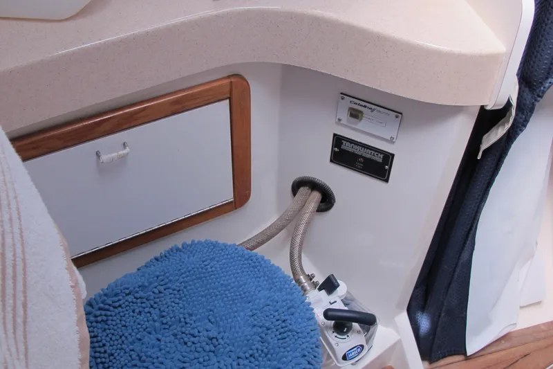 Slide: The Image of Interior of 1997 Catalina 42 MkII yacht, featuring control panel and cushioned seat. - 40