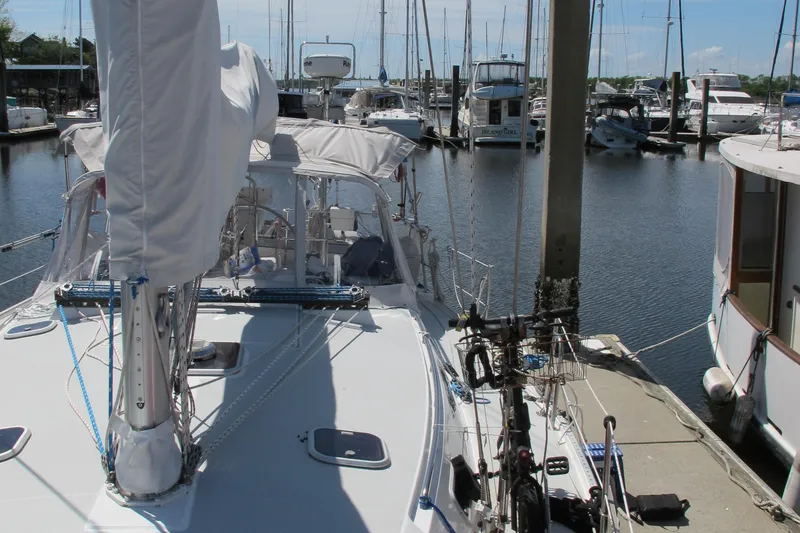 Slide: The Image of Catalina 42 MkII sailboat docked in marina, 1997 model, surrounded by other boats. - 5