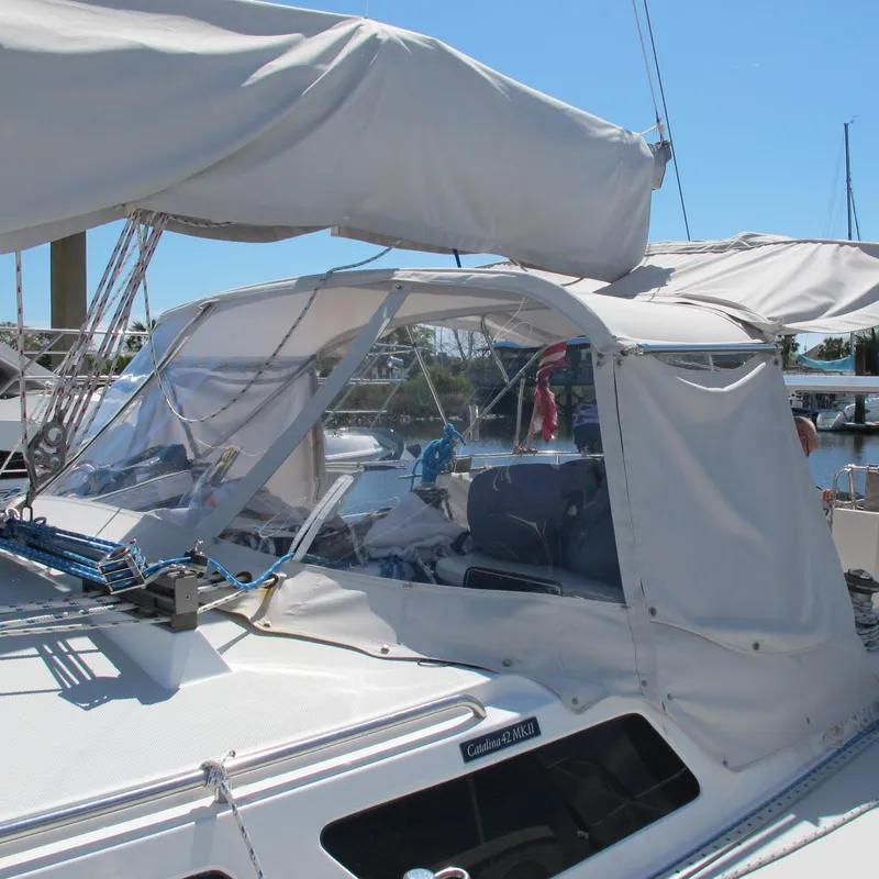 Slide: The Image of 1997 Catalina 42 MkII sailboat with covered cockpit, docked in a marina. - 7