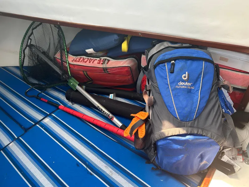 Slide: The Image of Fishing gear and backpack on a 1992 Dusky 256 boat. - 14