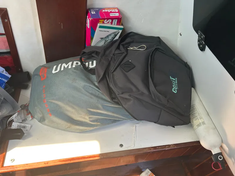 Slide: The Image of Backpack and gear on a 1992 Dusky 256 boat interior shelf. - 15