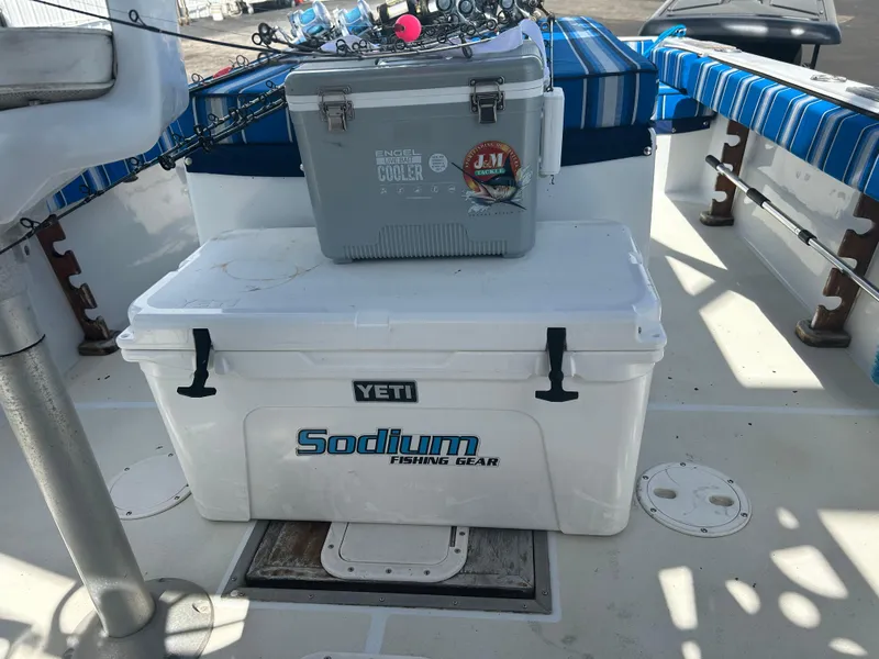 Slide: The Image of 1992 Dusky 256 boat deck with Yeti cooler and fishing gear. - 17