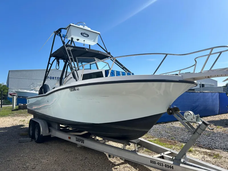 Slide: The Image of 1992 Dusky 256 boat on trailer under clear blue sky. - 2