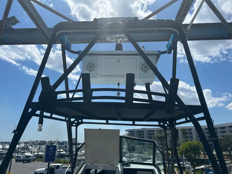 Slide: The Image of Dusky 256 boat from 1992 with tower, marina background, and clear sky. - 6