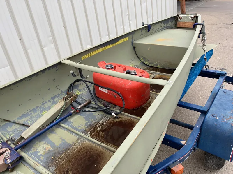 Slide: The Image of 1961 Grumman 19' Square Stern Canoe with red fuel tank on trailer. - 11