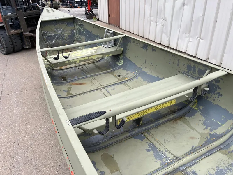 Slide: The Image of 1961 Grumman 19' Square Stern Canoe with weathered interior, parked outdoors. - 12