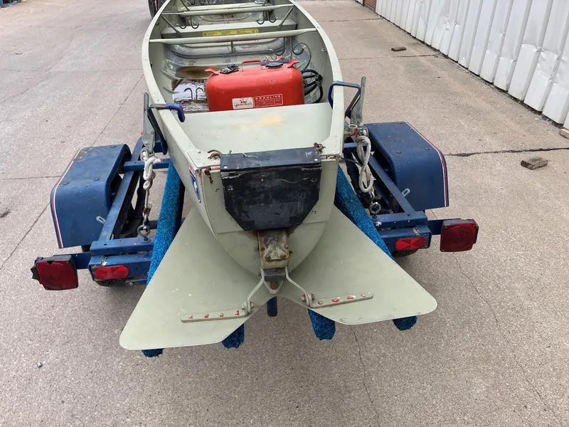 Slide: The Image of 1961 Grumman 19' Square Stern Canoe on trailer, featuring a red fuel tank. - 2