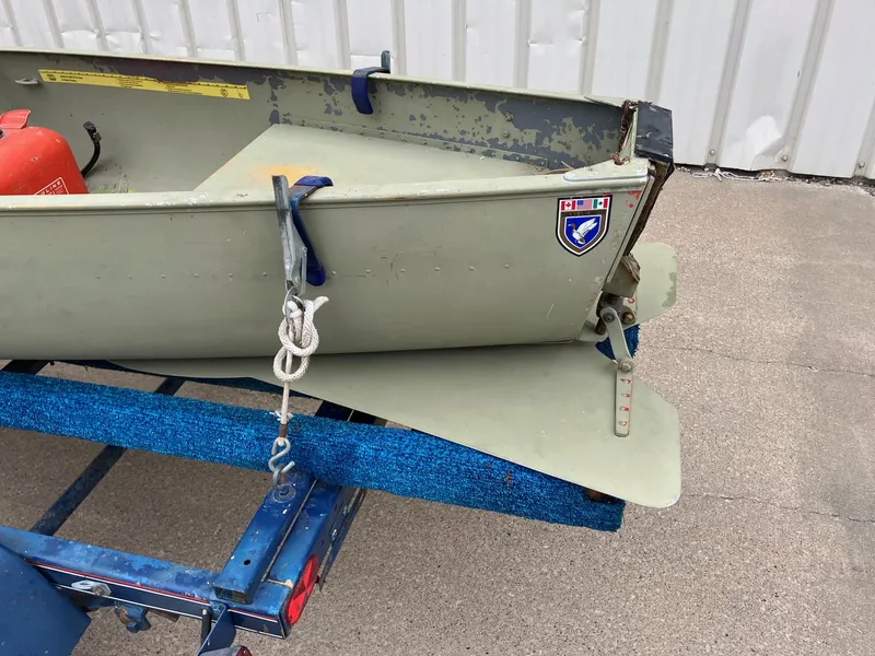 Slide: The Image of 1961 Grumman 19' Square Stern Canoe on trailer, featuring vintage design and emblem. - 7