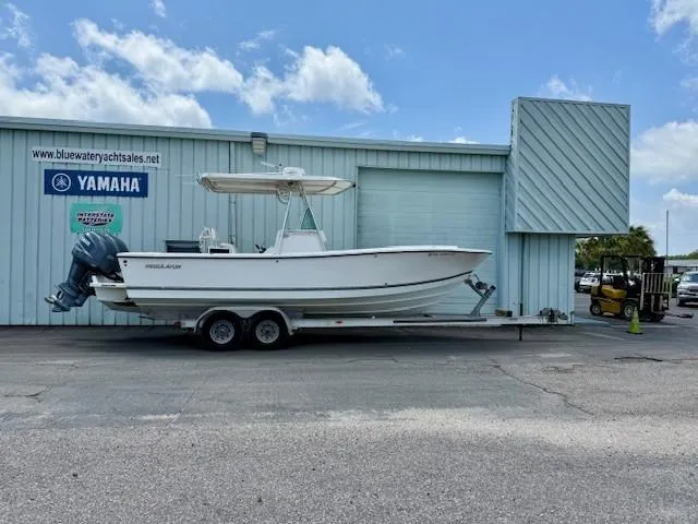 The Image of 2001 Regulator 26 Forward Seating boat on trailer outside dealership. - 0