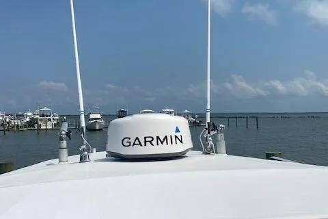 Slide: The Image of 2001 Regulator 26 Forward Seating boat with Garmin radar on calm waters. - 10