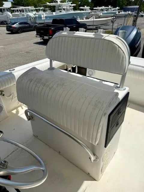 Slide: The Image of 2001 Regulator 26 Forward Seating boat interior with white cushioned seating and storage. - 7