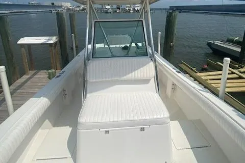 Slide: The Image of 2001 Regulator 26 Forward Seating boat docked by the water. - 9