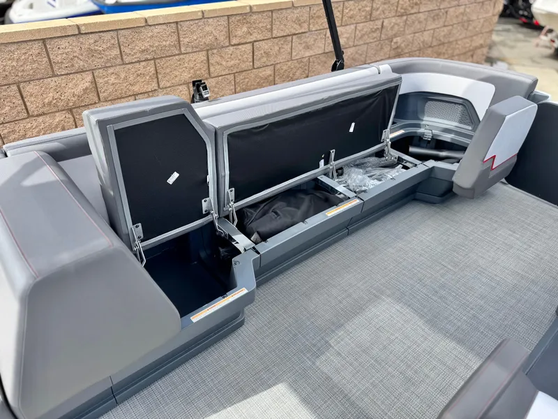 Slide: The Image of 2025 Manitou Cruise 20 Bench Twin Tube boat interior with open storage compartments. - 12