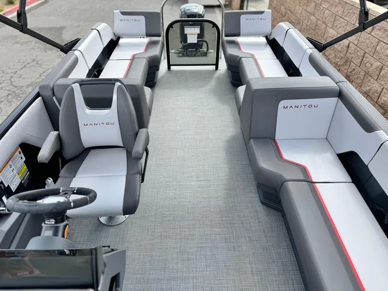 Slide: The Image of 2025 Manitou Cruise 20 Bench Twin Tube pontoon boat interior with modern seating. - 13