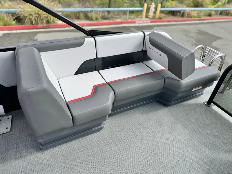 Slide: The Image of 2025 Manitou Cruise 20 Bench Twin Tube boat interior with modern gray and white seating. - 15
