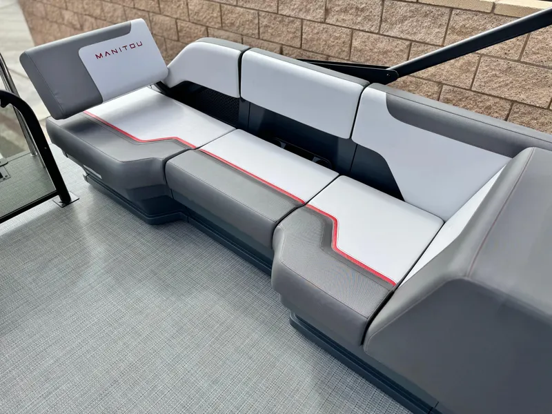 Slide: The Image of 2025 Manitou Cruise 20 Bench Twin Tube boat seating with modern design and gray upholstery. - 16