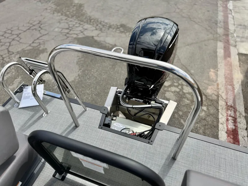 Slide: The Image of 2025 Manitou Cruise 20 Bench Twin Tube boat with outboard motor and ladder. - 18