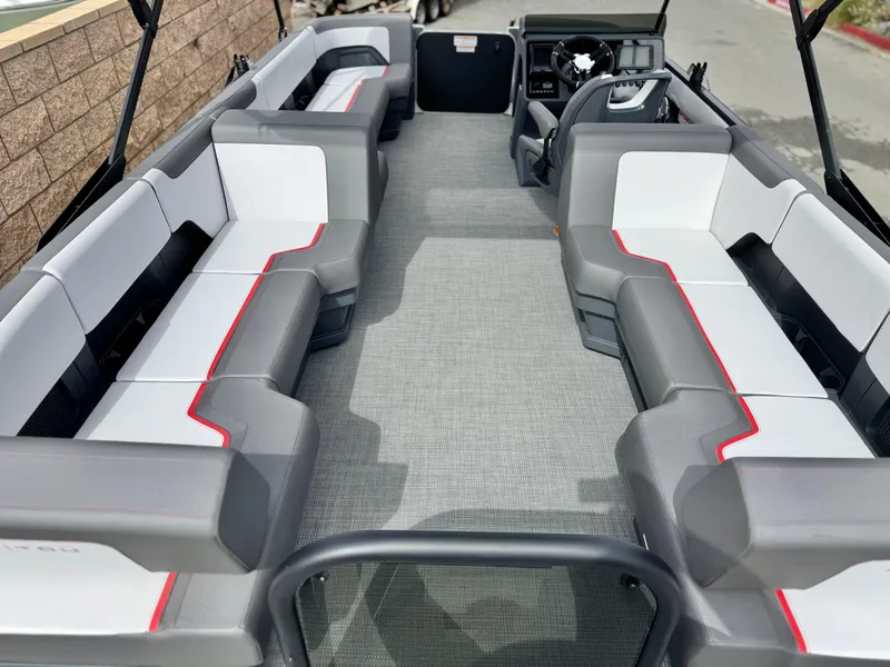 Slide: The Image of 2025 Manitou Cruise 20 Bench Twin Tube pontoon boat interior with spacious seating and modern design. - 19