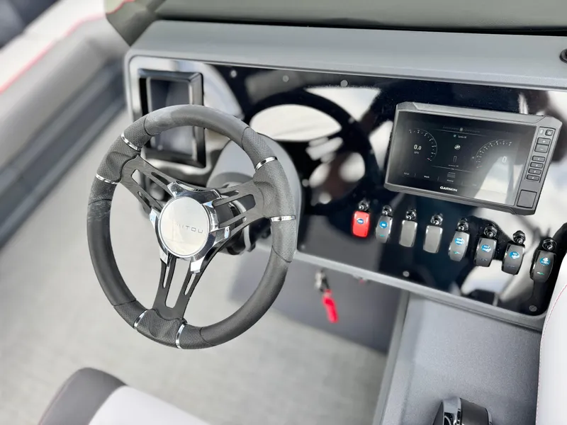 Slide: The Image of Steering console of 2025 Manitou Cruise 20 Bench Twin Tube with modern controls and display. - 22