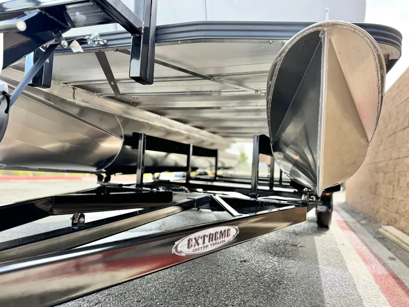 Slide: The Image of Underneath view of 2025 Manitou Cruise 20 Bench Twin Tube pontoon boat on trailer. - 3