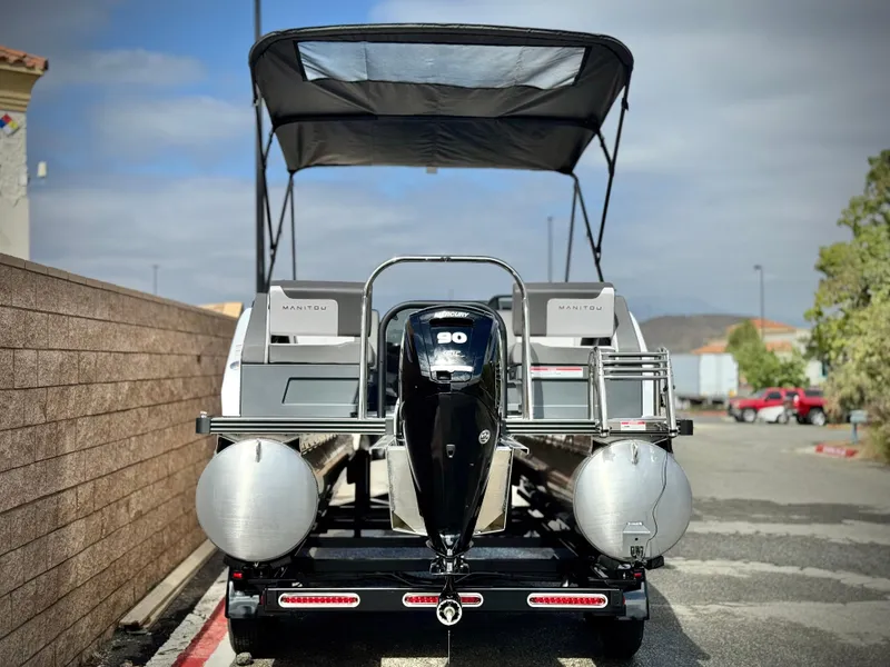 Slide: The Image of 2025 Manitou Cruise 20 Bench Twin Tube pontoon boat with canopy and outboard motor. - 5