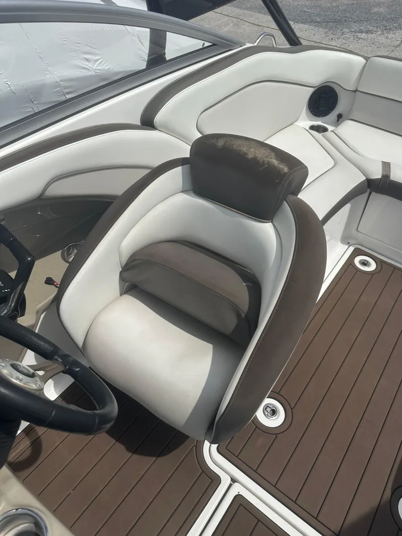 Slide: The Image of 2013 Yamaha Boats 242 Limited S interior with brown and white seating. - 12