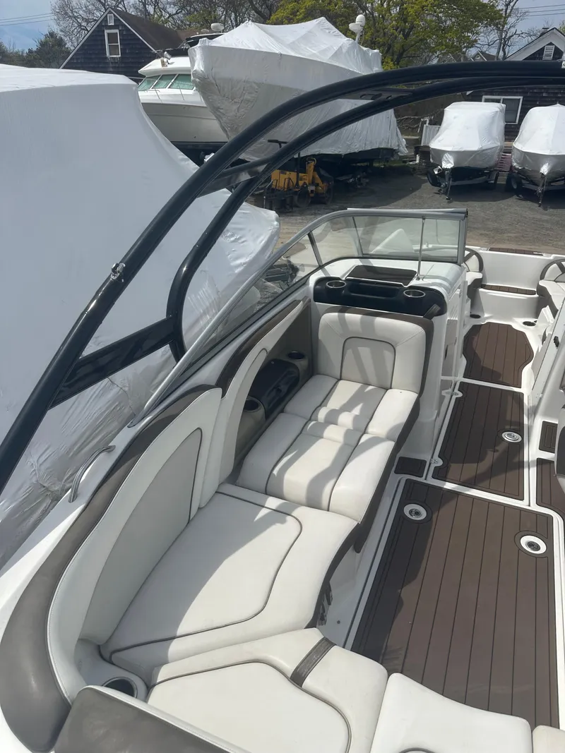 Slide: The Image of 2013 Yamaha Boats 242 Limited S interior with white seating and sleek design. - 13