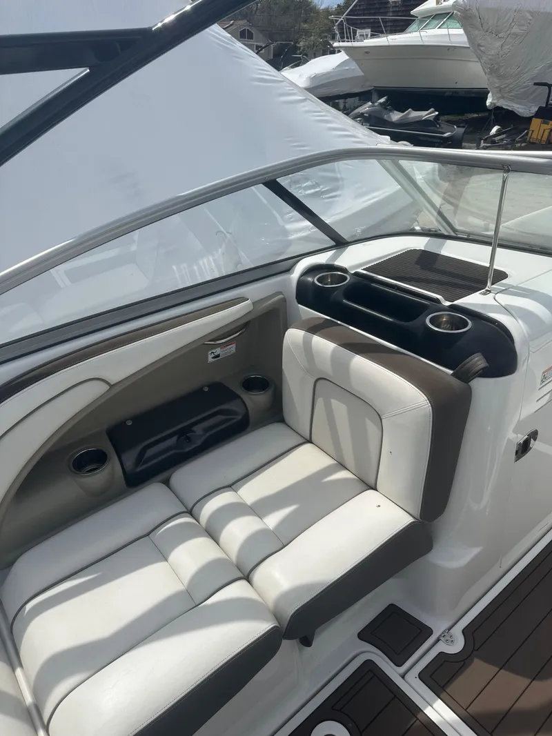 Slide: The Image of 2013 Yamaha Boats 242 Limited S interior with white seating and cup holders. - 15