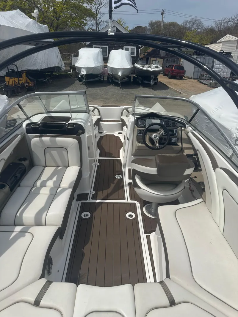 Slide: The Image of 2013 Yamaha Boats 242 Limited S interior with sleek seating and modern dashboard. - 4