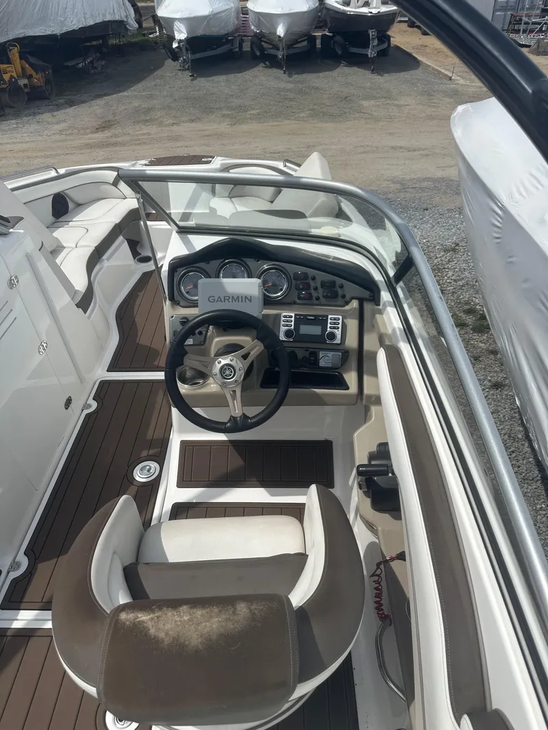Slide: The Image of 2013 Yamaha Boats 242 Limited S cockpit with steering wheel and dashboard controls. - 5