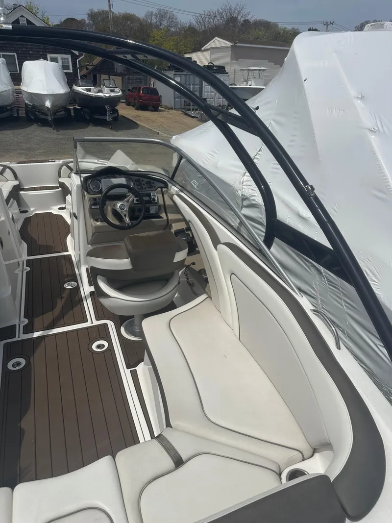 Slide: The Image of 2013 Yamaha Boats 242 Limited S interior with sleek seating and modern dashboard. - 6