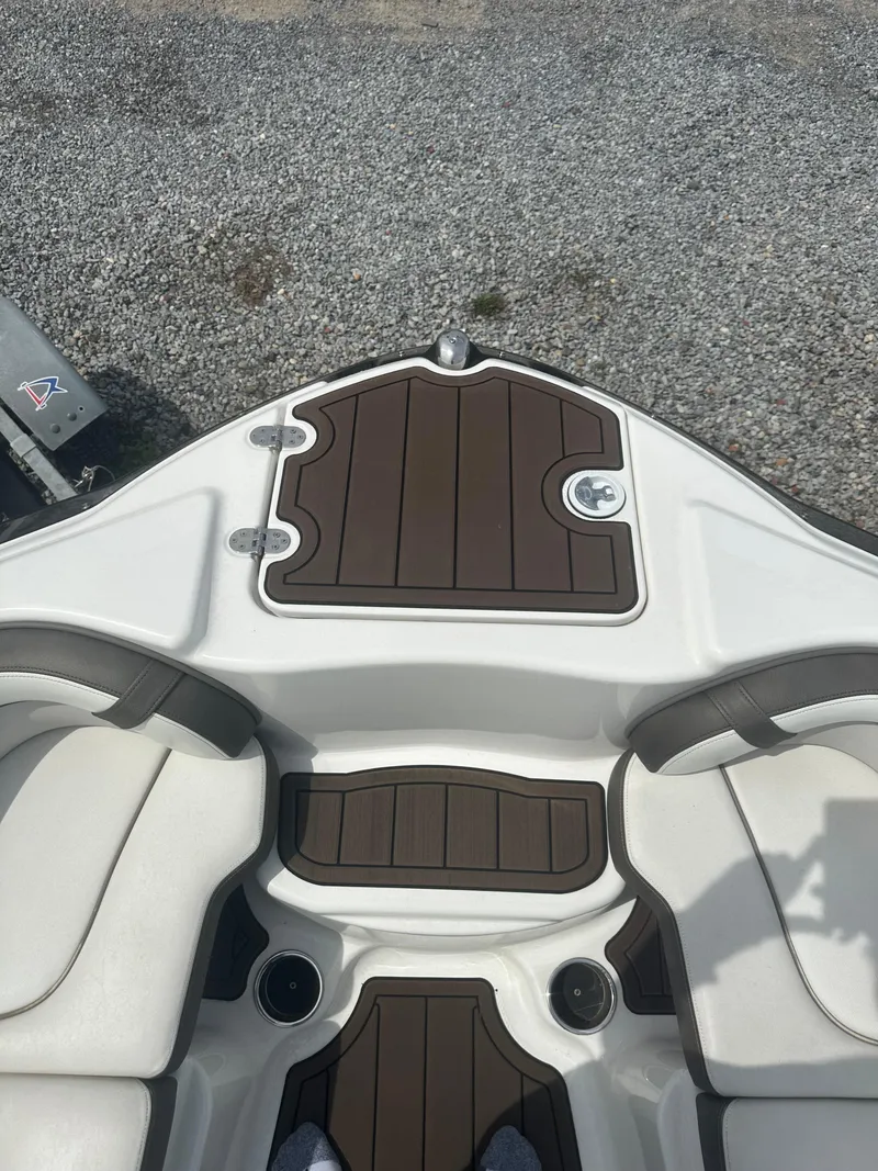 Slide: The Image of 2013 Yamaha Boats 242 Limited S interior with brown and white seating. - 8
