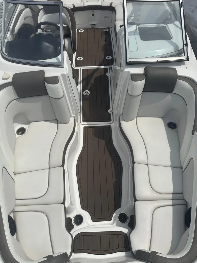 Slide: The Image of 2013 Yamaha Boats 242 Limited S interior with white seating and brown flooring. - 9