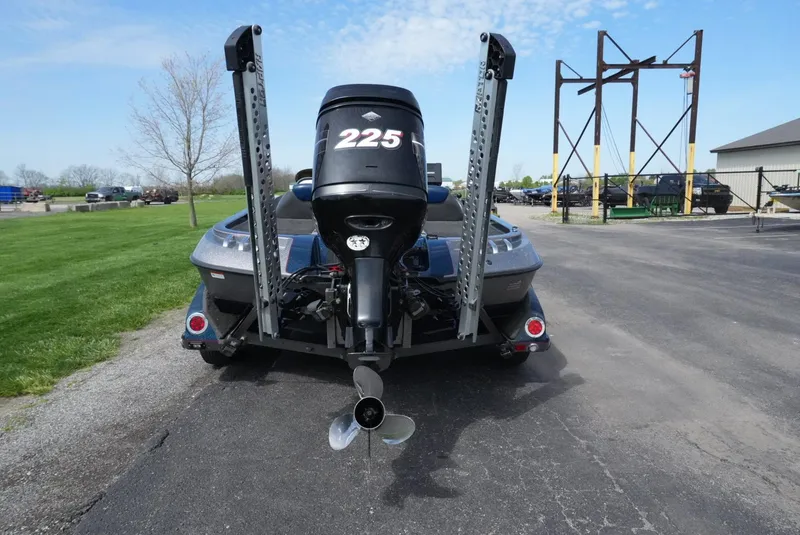 Slide: The Image of 2005 Ranger Z20 boat with powerful outboard motor, parked on asphalt near grassy area. - 11