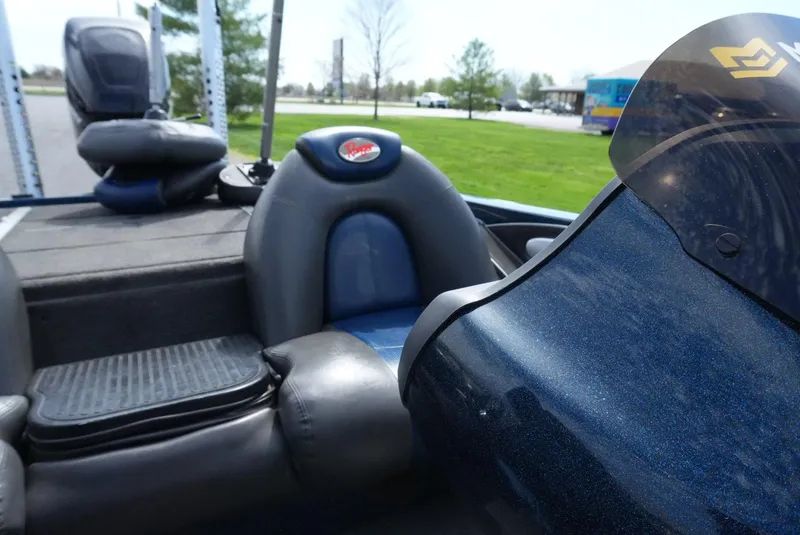 Slide: The Image of 2005 Ranger Z20 boat interior with blue and black seating, windshield, and outdoor background. - 15
