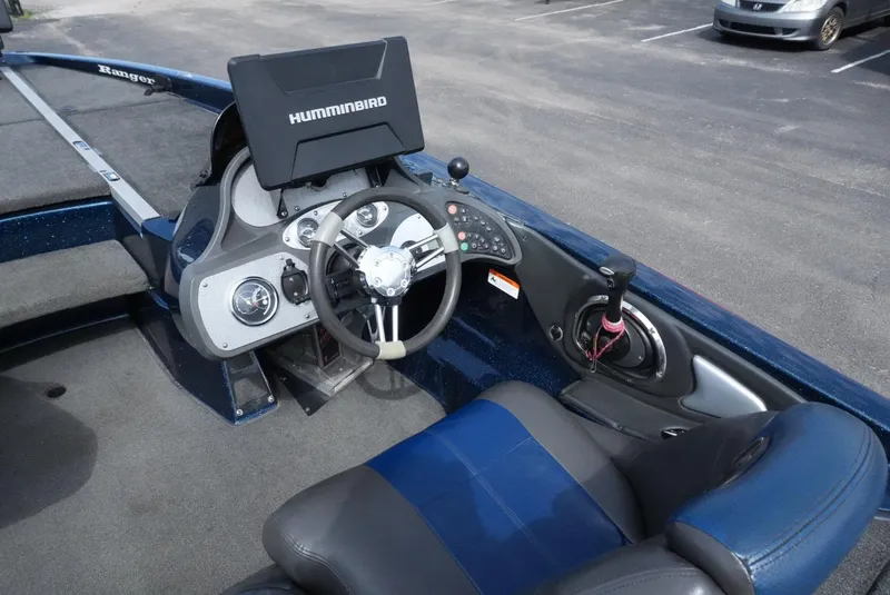 Slide: The Image of 2005 Ranger Z20 boat cockpit with steering wheel and Humminbird fish finder. - 17