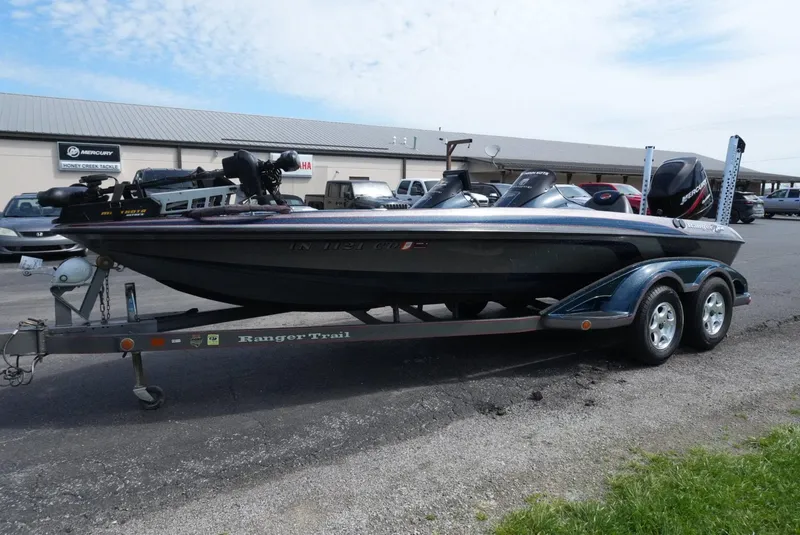 Slide: The Image of 2005 Ranger Z20 boat on trailer, parked outdoors near a building. - 3