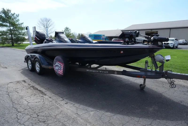 Slide: The Image of 2005 Ranger Z20 boat on trailer, parked outdoors near a building. - 4