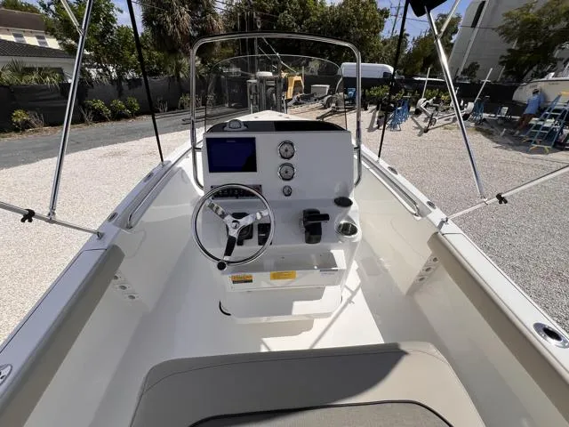 Slide: The Image of 2025 Key West 189 FS boat interior with steering console and navigation display. - 11
