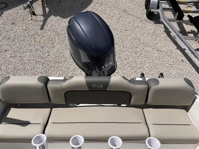 Slide: The Image of 2025 Key West 189 FS boat with cushioned seating and outboard motor. - 14