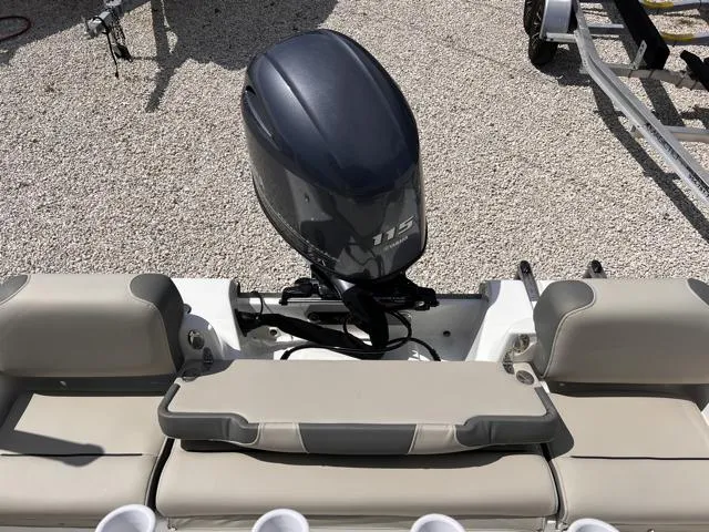 Slide: The Image of 2025 Key West 189 FS boat with 115 HP outboard motor, beige seating, and cup holders. - 15