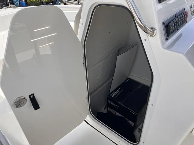 Slide: The Image of Open storage compartment on 2025 Key West 189 FS boat, showing interior space. - 25