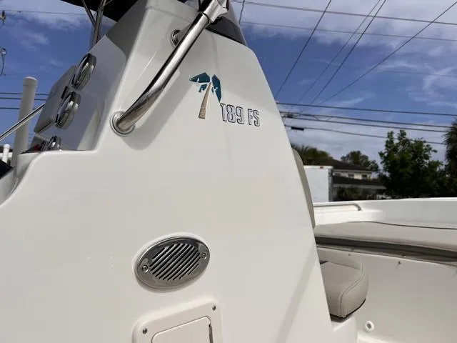 Slide: The Image of 2025 Key West 189 FS boat console with logo, under a clear blue sky. - 27