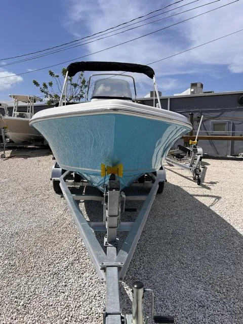 Slide: The Image of 2025 Key West 189 FS boat on trailer, blue hull, parked outdoors. - 3