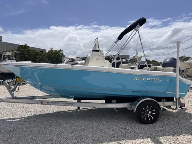 Slide: The Image of 2025 Key West 189 FS boat in light blue on a trailer, parked outdoors. - 5