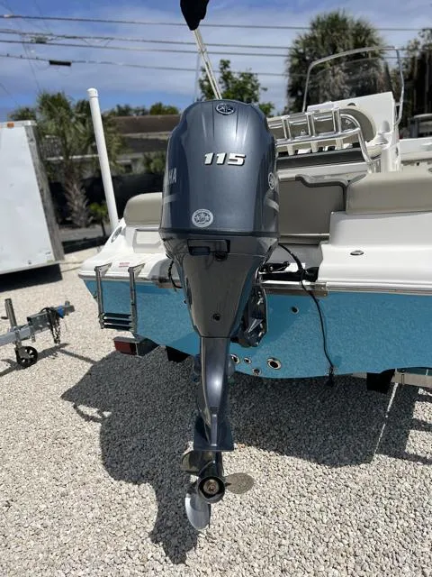 Slide: The Image of 2025 Key West 189 FS boat with Yamaha 115 outboard motor, parked on gravel. - 7