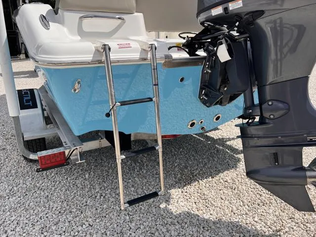 Slide: The Image of 2025 Key West 189 FS boat with ladder and motor on gravel surface. - 8